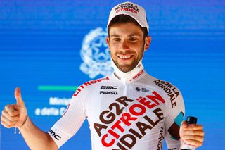 Team AG2R rider Italys Andrea Vendrame celebrates on the podium after winning the twelfth stage of the Giro dItalia 2021 cycling race 212 km between Siena and Bagno di Romagna on May 20 2021 Photo by Luca Bettini AFP Photo by LUCA BETTINIAFP via Getty Images