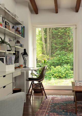 White office with wooden floors and large window