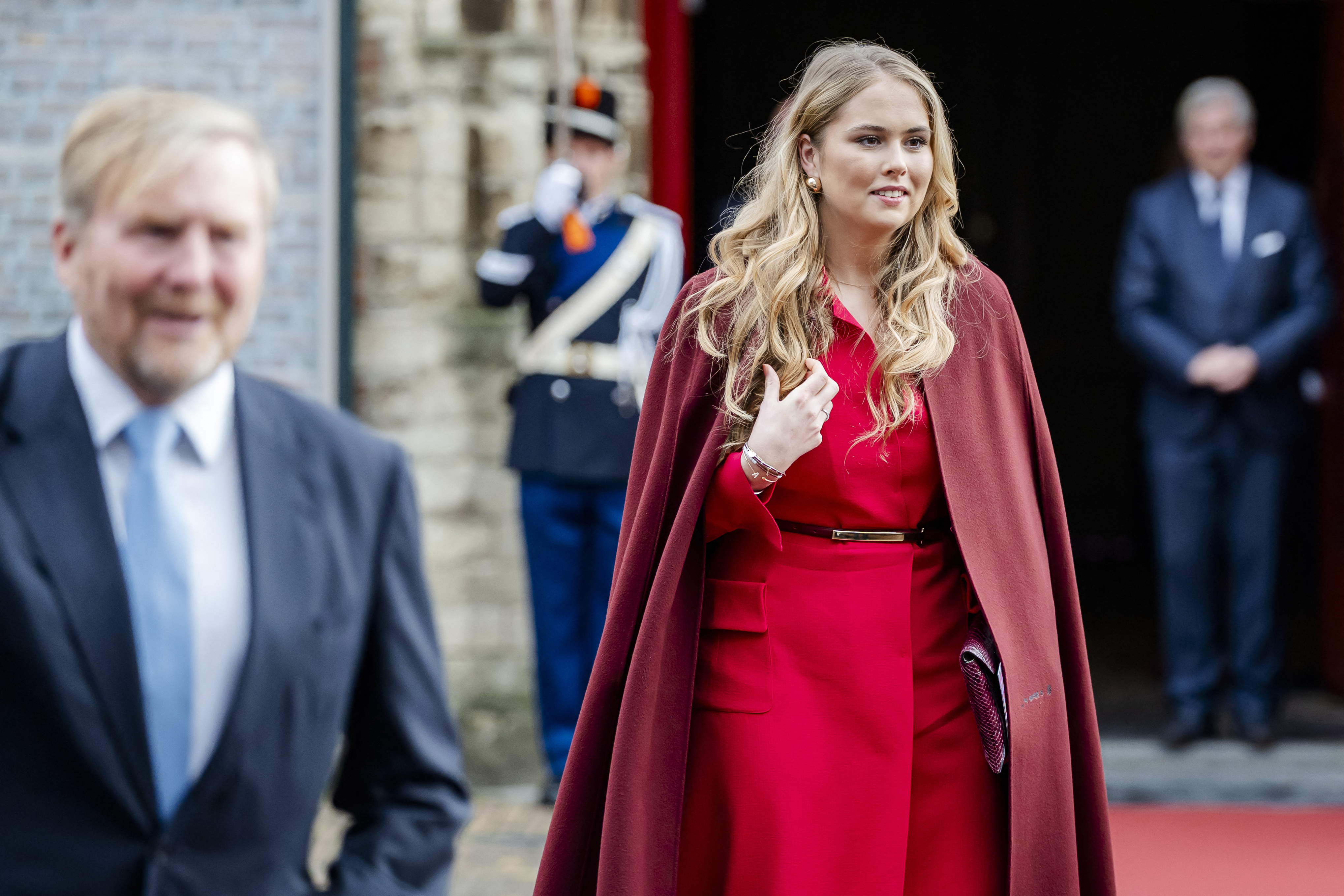 Princess Catharina-Amalia in a red dress and maroon cape