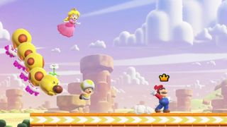 Mario slides across a platform as Princess Peach and Toad soar through the air behind him alongside a Wiggler in co-op platformer, Super Mario Bros. Wonder