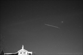 NASA's space shuttle Discovery and the International Space Station are seen in this time-lapse image as they fly over Leiden, The Netherlands, just before the two spacecraft docked on March 17, 2009 during the STS-119 mission. The shuttle is the object sl