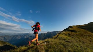 Woman running across a ridge