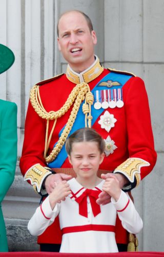 Prince William holds onto Princess Charlotte's shoulders at Trooping the Colour