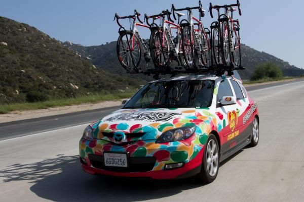The team car carries bikes to an early-season criterium in southern California, a race used as a test lab for team leadout training.