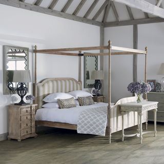 bedroom with four poster bed and bedside table