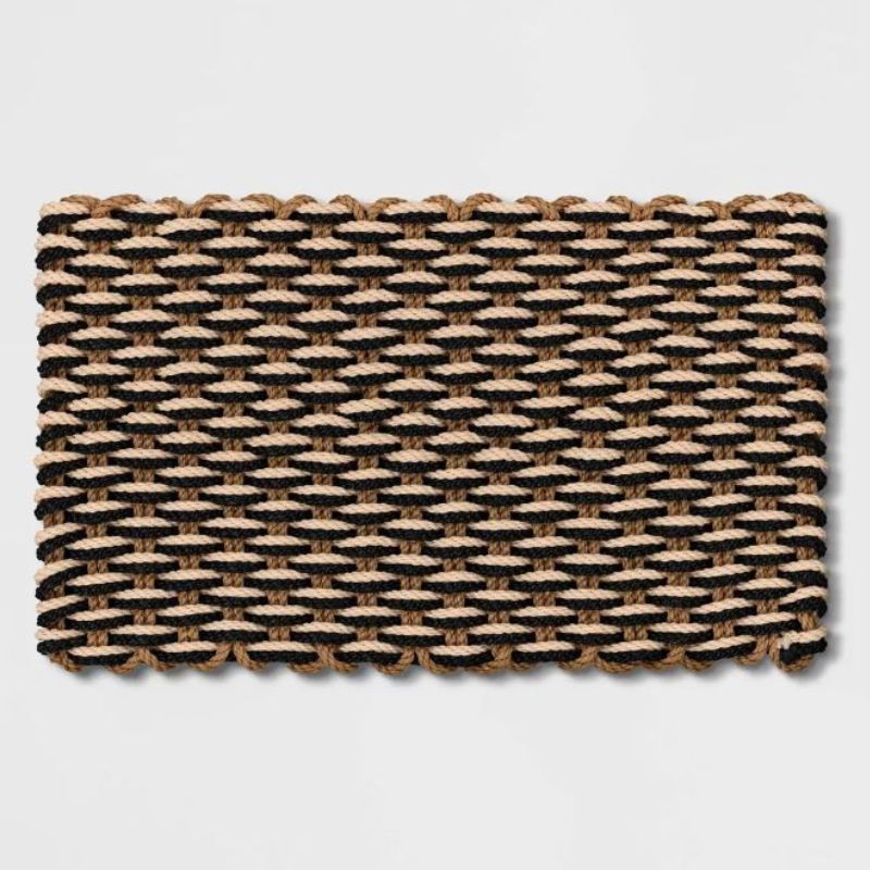 A brown. black, and cream robe braided doormat is one of the best Target fall decor items for outside.
