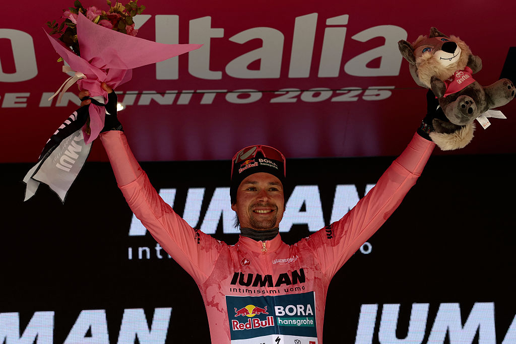 Red Bull-Bora-Hansgrohe's Slovenian rider Primoz Roglic celebrates the Pink jersey of the overall leader on the podium after the 7th stage of the 108th Giro d'Italia cycling race 168kms from Castel di Sangro to Tagliacozzo on May 16, 2025. (Photo by Luca Bettini / AFP)