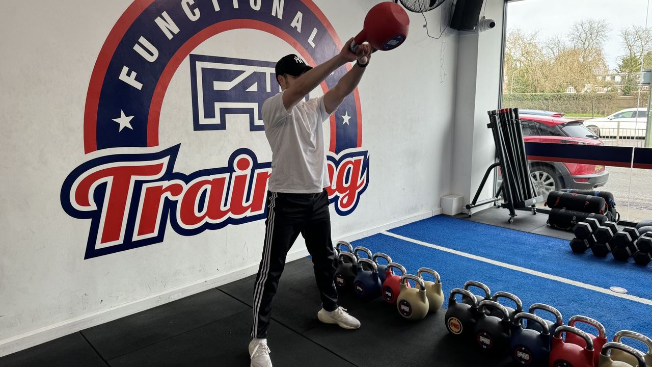 F45 personal trainer demonstrates a kettlebell swing