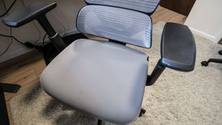 The adjustable armrests and the seat of the ProtoArc EC100 office chair