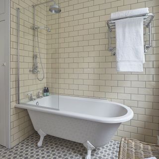 rolltop bath cream white wall tiles grey floor tiles towel rail