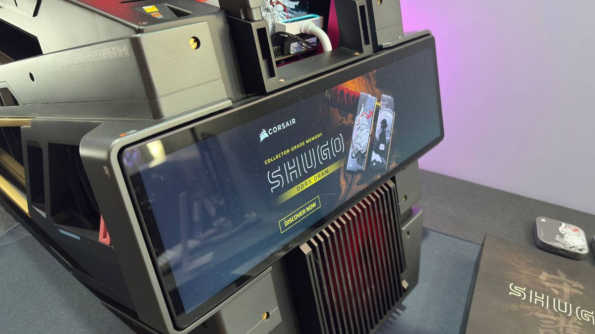 An RGB samurai sword on a pedestal that is actually a PC. The words 'Shugo' can be seen on the wall behind the exhibition piece from Corsair.