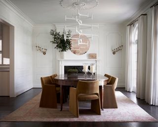 dining room with white panelled walls, large wooden dining table and modern chairs