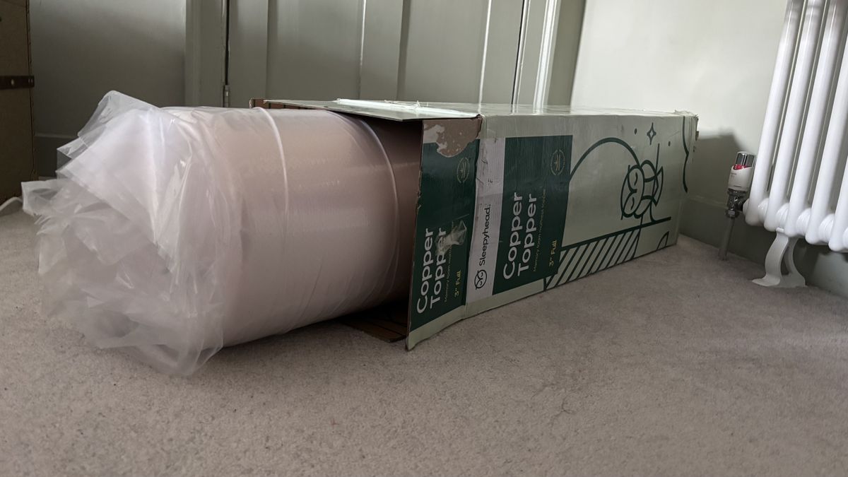 The vacuum-packed Sleepyhead Cooling Copper Topper coming out of its box