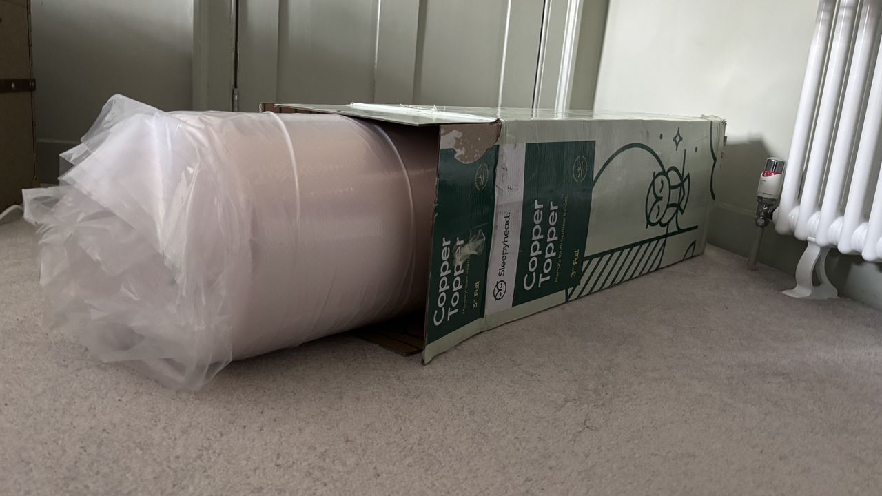The vacuum-packed Sleepyhead Cooling Copper Topper coming out of its box