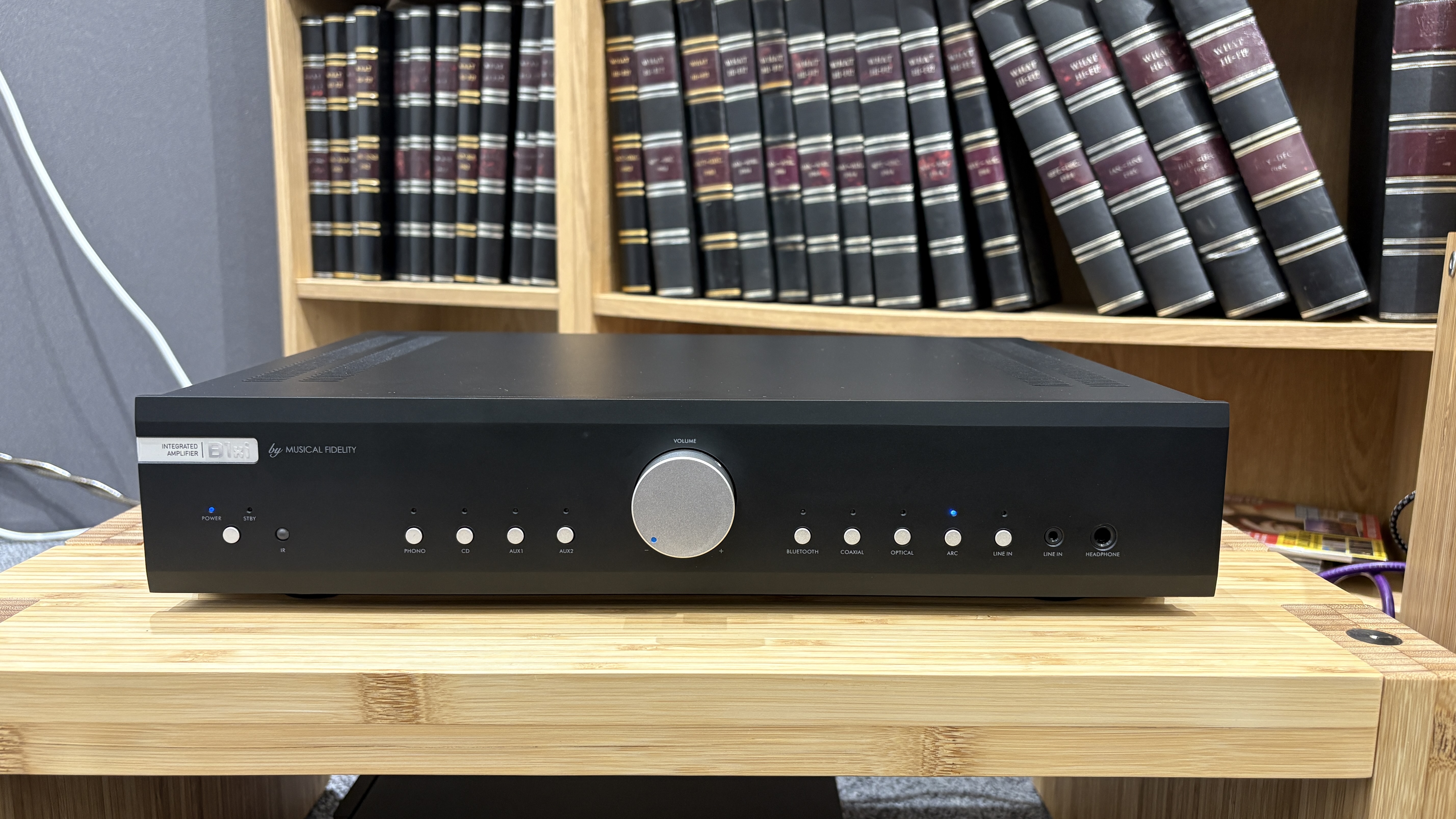 Musical Fidelity B1xi amplifier on wooden rack in test room