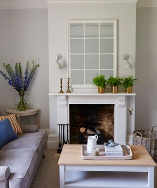 Fireplace in Old Rectory with pendant lights and large white mirror by Sims Hilditch