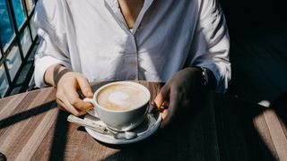 Woman drinking latte coffee