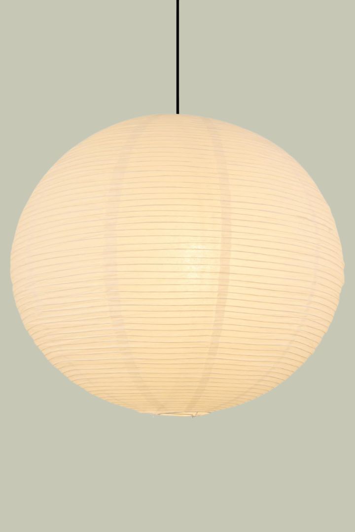 White Paper Lamp Shade against pale green background.