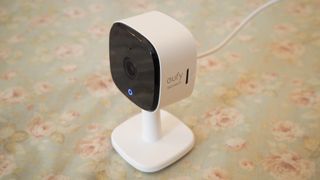 Eufy Indoor Cam C120 on a flowery patterned surface