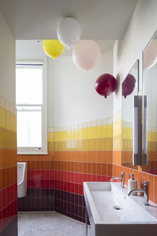 Groucho Club toilets featuring colourful tiles - balloons in shot