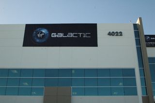 Virgin Galactic's temporary banner proclaimed the opening of the new facility at Long Beach Airport in Southern California last Saturday. Almost 7,000 people attended the combined opening and job fair.