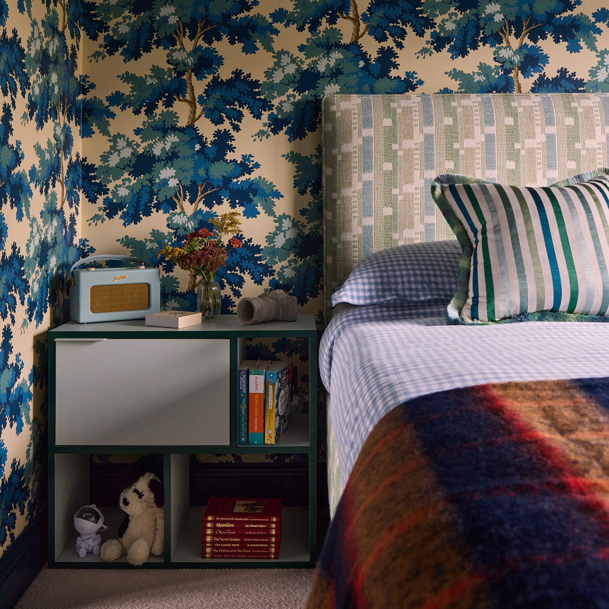 blue and cream patterned wallpaper in bedroom with green blue and cream headbaord and blue gingham bedlinen studio raymond