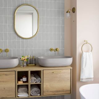 budget bathroom updates, wall mounted double sink vanity, grey tiles, blush walls, brass taps, mirror wall light