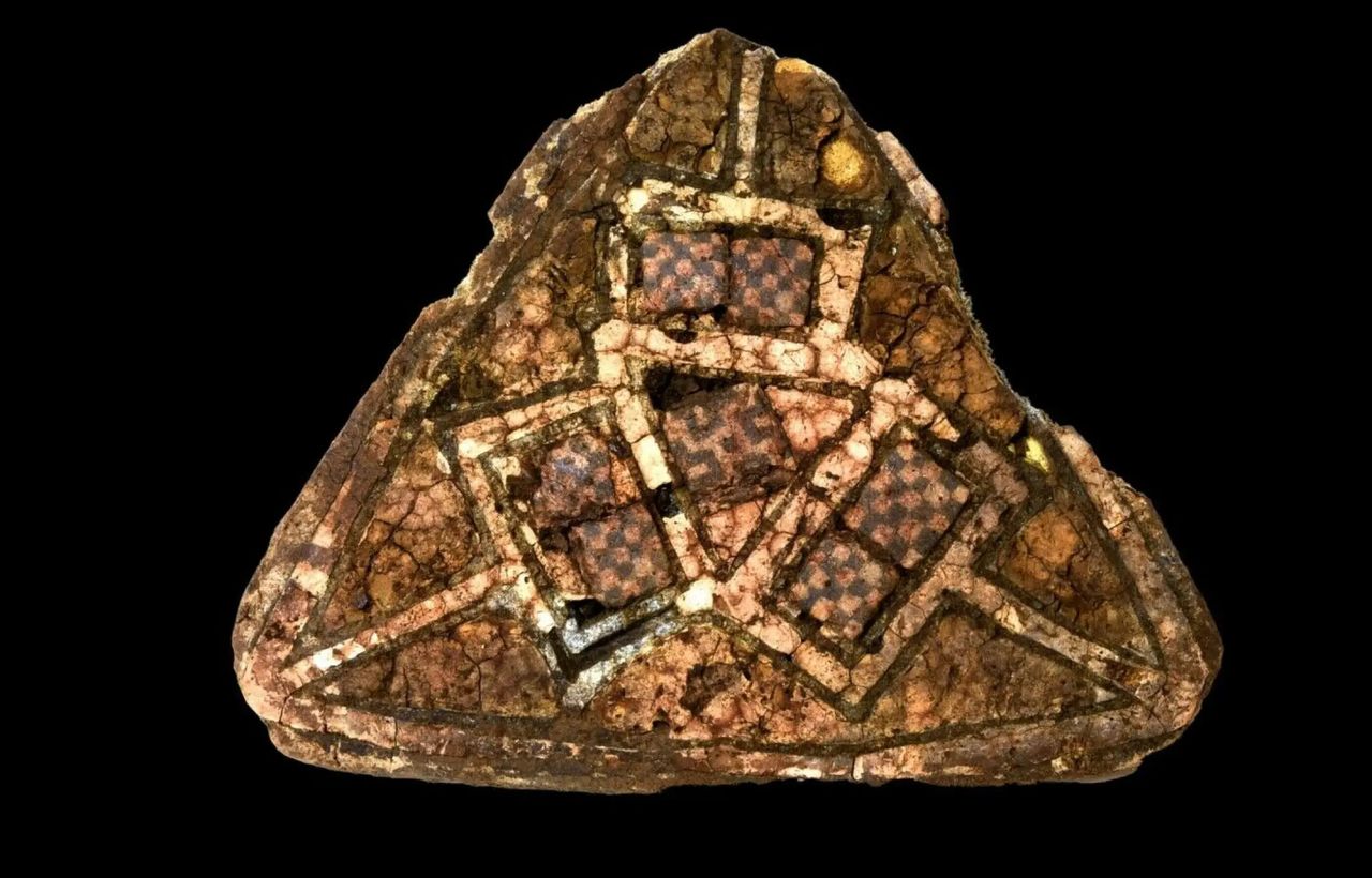 A triangular brooch.