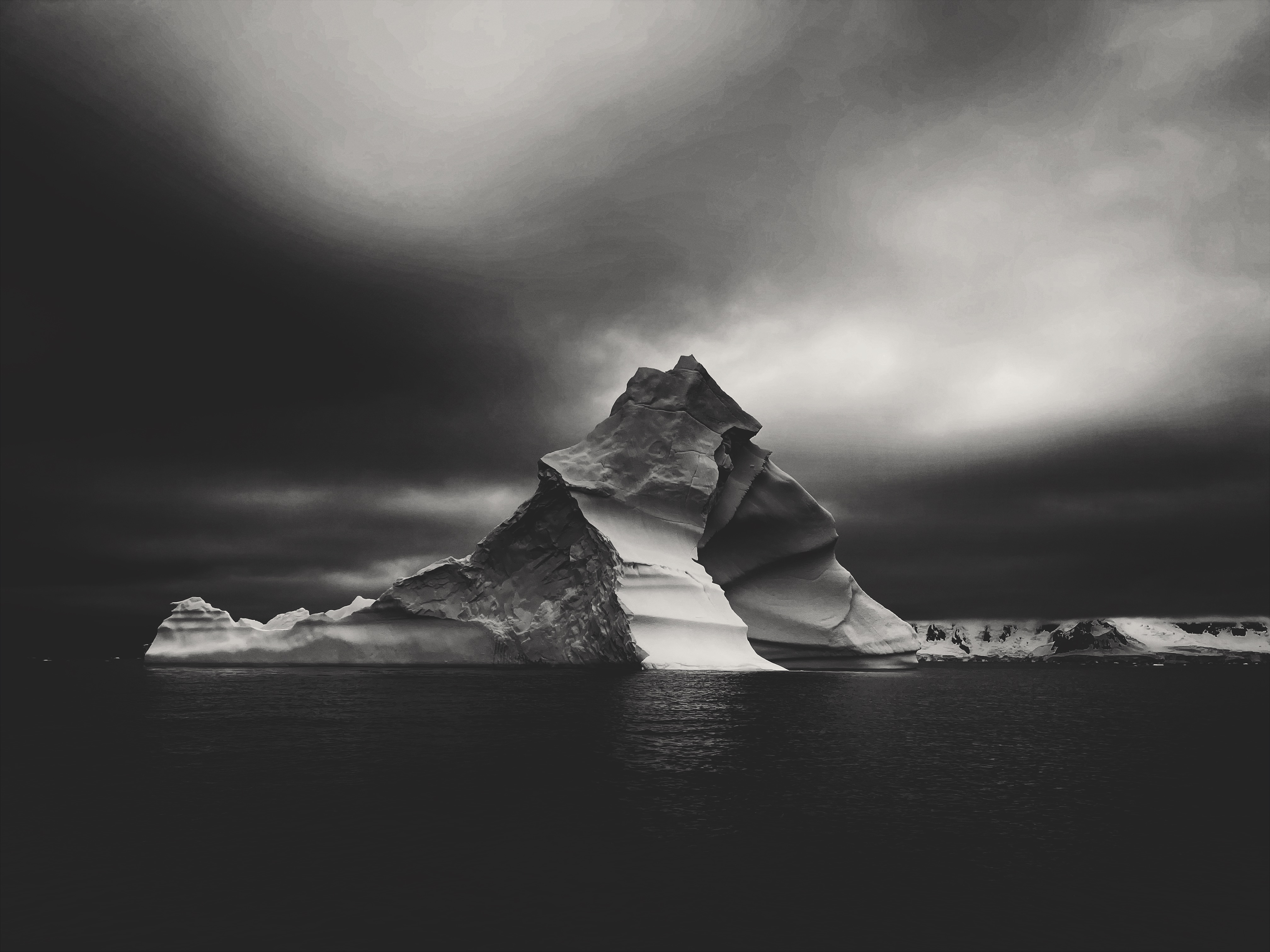 An iceberg under a dark sky