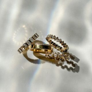 Several diamond eternity bands on white background.