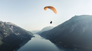 what is paralpinism: paragliding over lake