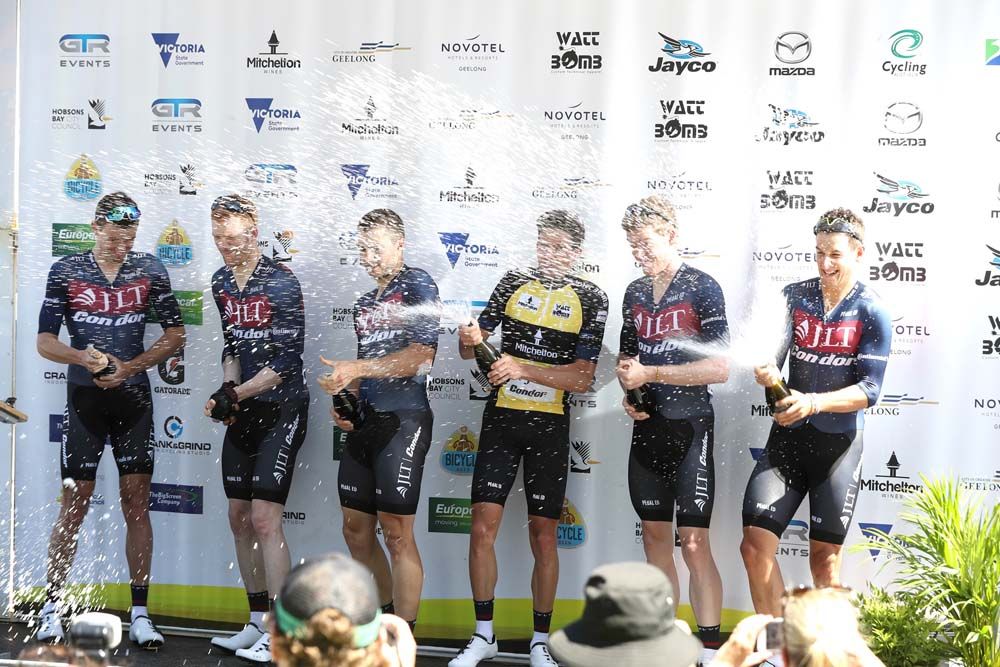The riders celebrate on the podium