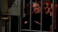 Eric Braeden as Victor smirking on the other side of his cellar in The Young and the Restless