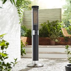 The Swan column patio heater outdoors on a paved patio