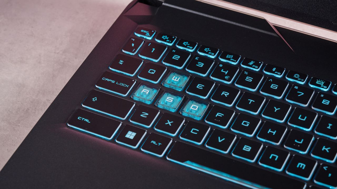 Close-up of WASD keys on the MSI Cyborg 15 A13U, with blue backlighting on