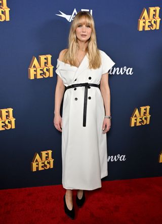 Pregnant Jennifer Lawrence attends the 2024 AFI Fest "Zurwaski V Texas" premiere at TCL Chinese Theatre on October 23, 2024 in Hollywood, California in a white blazer dress and black belt