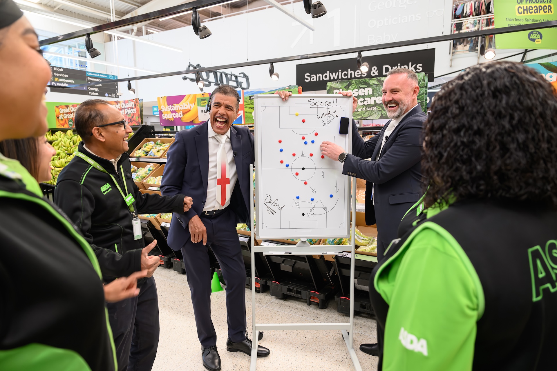 Chris Kamara demonstrating rules to Asda employees