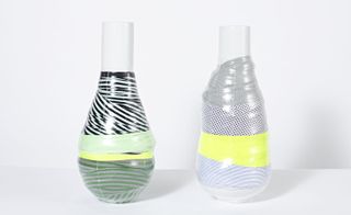 Protected Vases' are a duo of ceramic vessels enriched with adhesive tape and fabrics