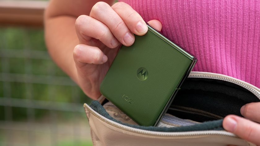 Putting a green Motorola Razr Plus 2024 into a small purse