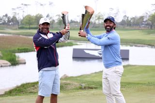Pablo Larrazabal celebrates with his caddie as both hold trophies