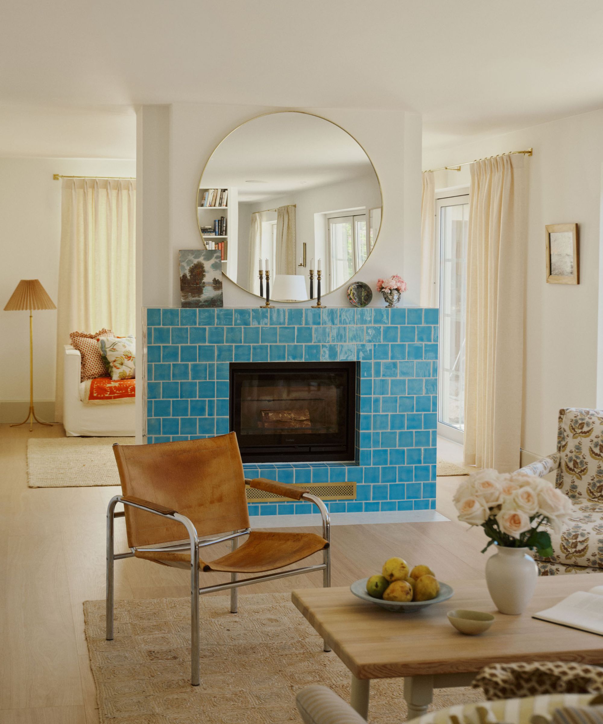 a neutral beach house living room with a blue tiled fireplace