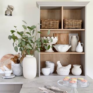 Display shelving with ceramics on a kitchen worktop in a country-style kitchen