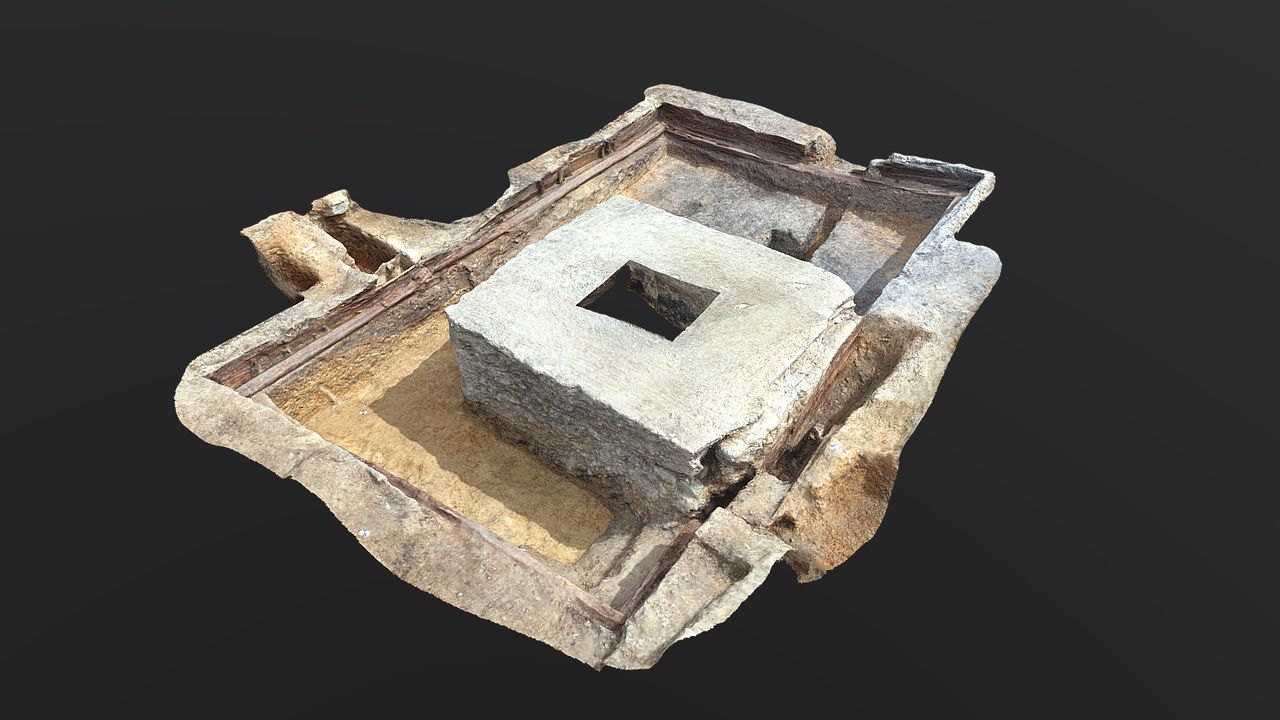 The rectangular timber structure, thought to be the remains of the stage of the 16th century theater, is now dominated by the concrete pillar of a warehouse built in the 1960s.