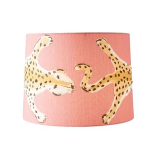 A coral tapered lampshade with a yellow and brown spotted leopard illustration wrapped around it