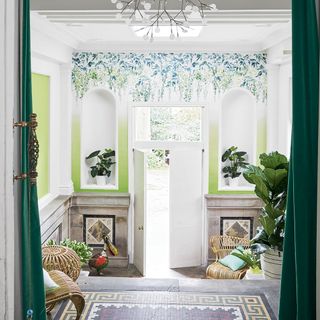 hallway with wallpaper on wall and white front door