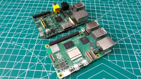 Raspberry Pi 5 placed near an older Raspberry Pi on a board