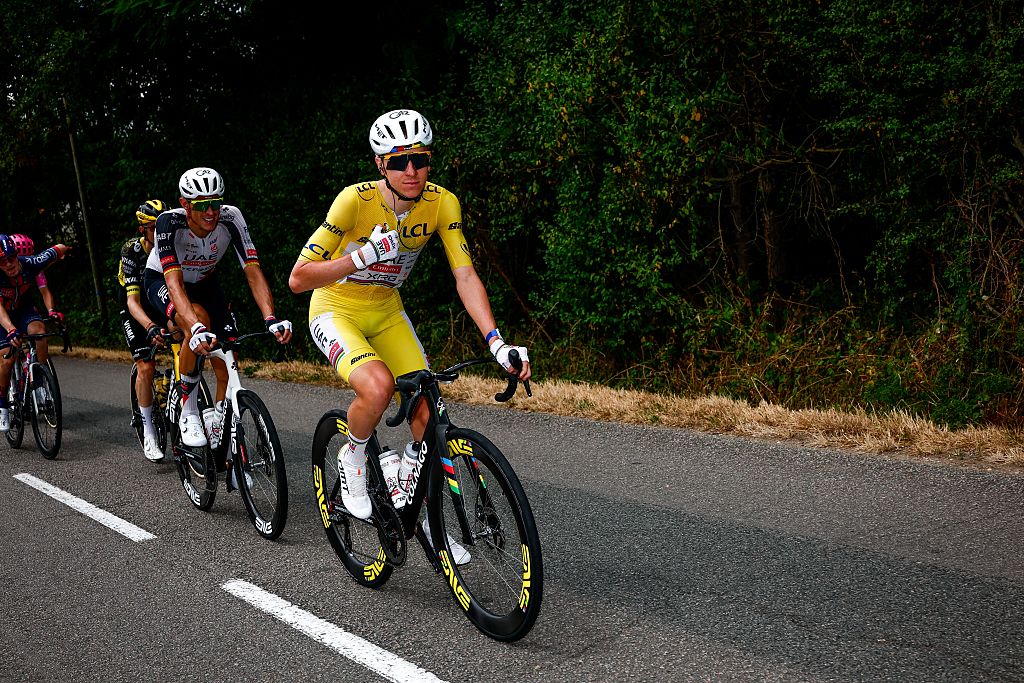 Pogacar in the yellow jersey riding ahead of teammates
