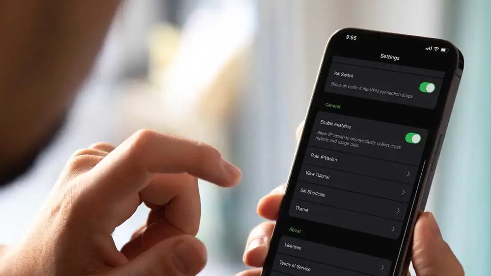 A man turning on the IPVanish kill switch tool on a smartphone.