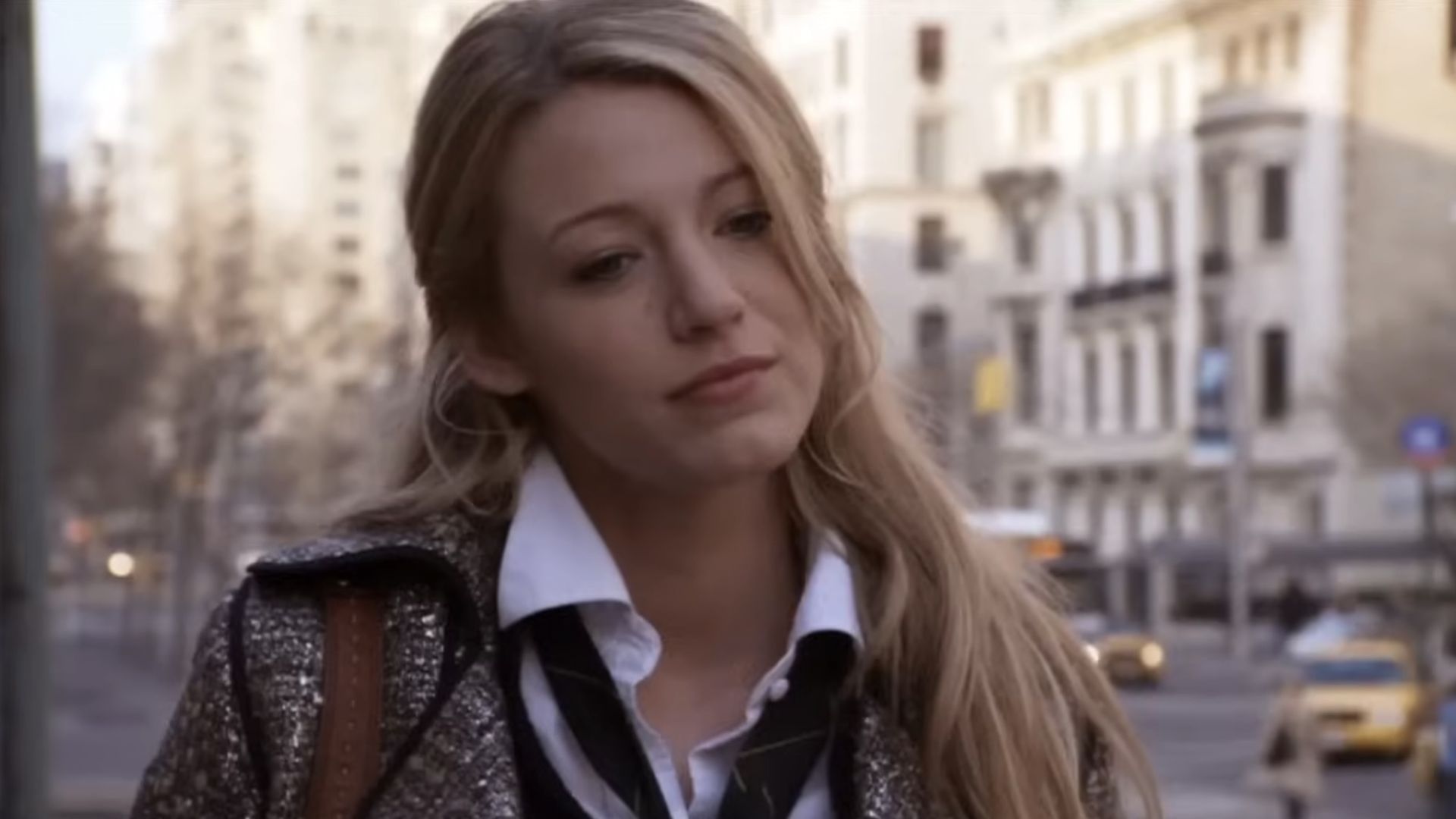 Blake Lively looking down in a blazer during the first episode of Gossip Girl.