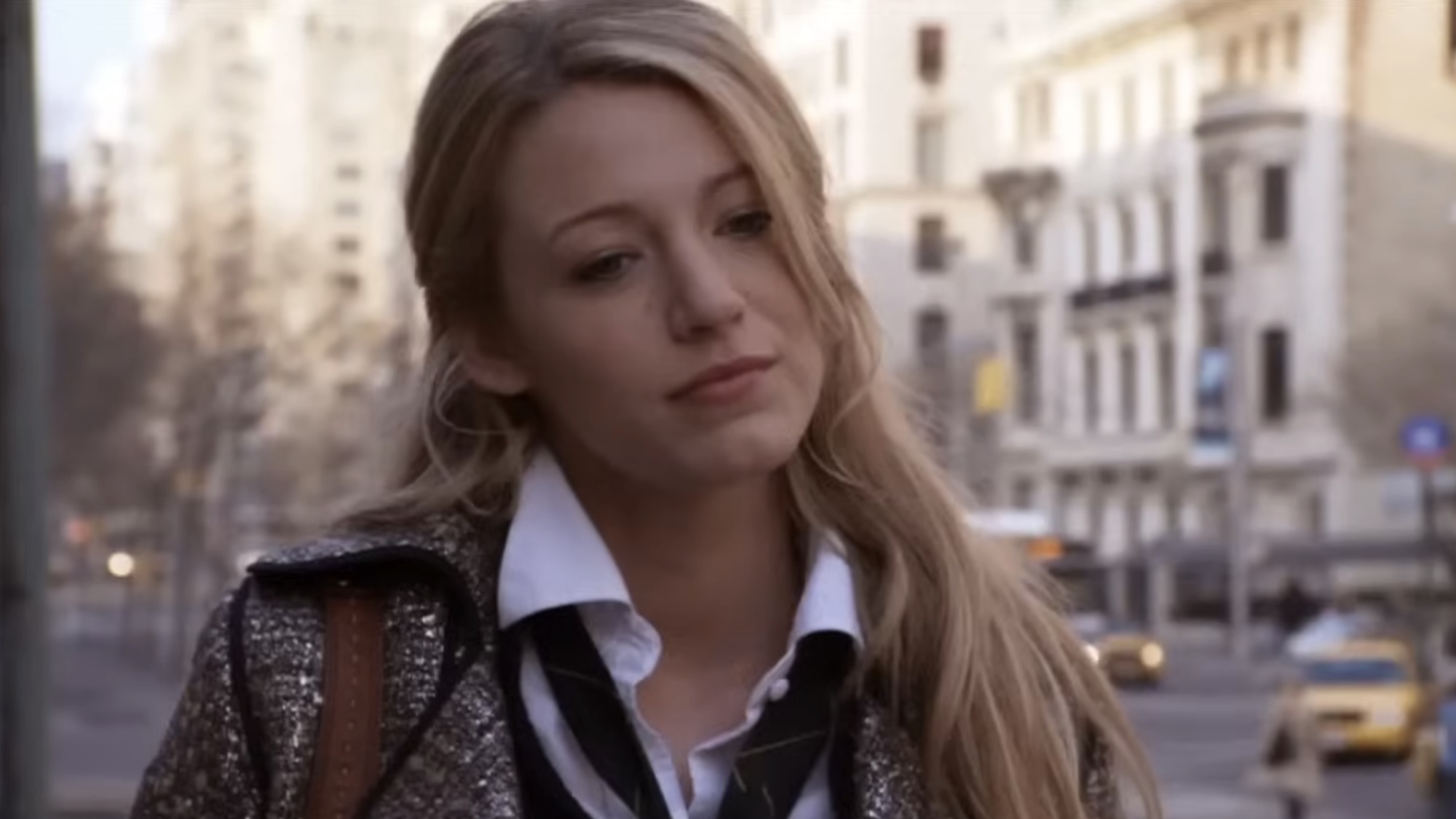 Blake Lively looking down in a blazer during the first episode of Gossip Girl.